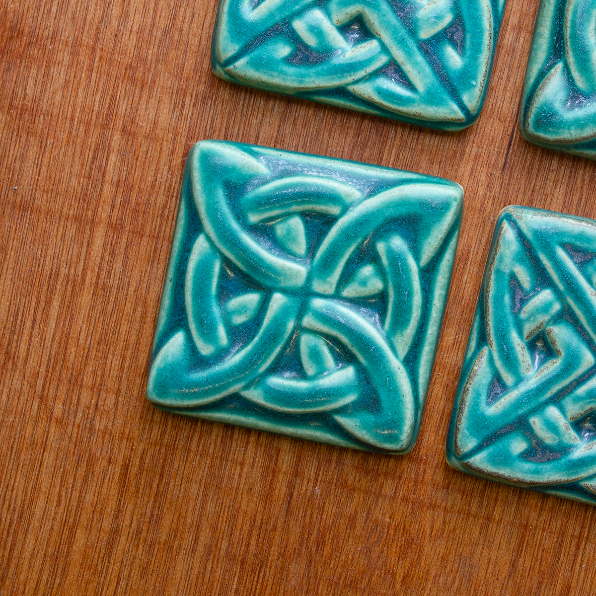 This Lover's Knot features the matte turquoise Pewabic Blue glaze.