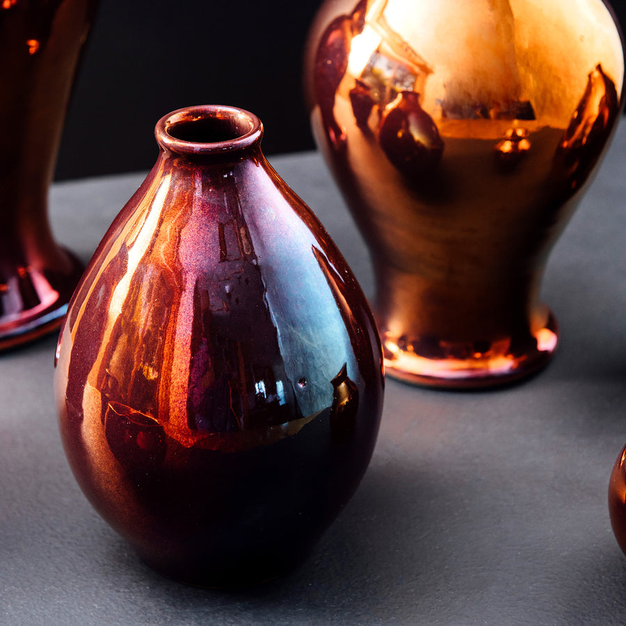 This vase's Copper glaze features more reds and purples in its finish.