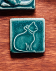 This ceramic cat tile is featured in the matte blueish-green Pewabic Green glaze.