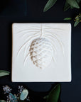 This Ceramic 6X6 Pine Cone Tile is shown in the Alabaster white glaze.