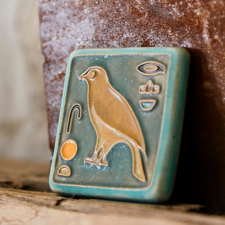 First designed in the 1920s, this hand-painted 3x3 tile depicts the bird hieroglyph Horus, the falcon-headed God of Light.