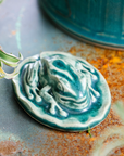 This Frog Paperweight features the matte blueish-green Pewabic Green glaze.