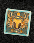 The Scarab Tile features a line drawing of a scarab beetle with wings outstretched and two small circles floating between its front arms. The design has classic Egyptian markings.