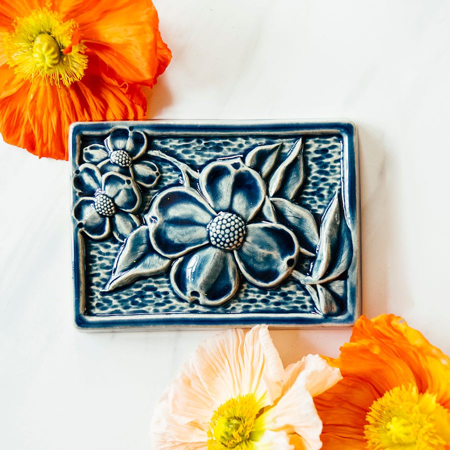 This Dogwood Tile features the glossy deep blue Ocean glaze.