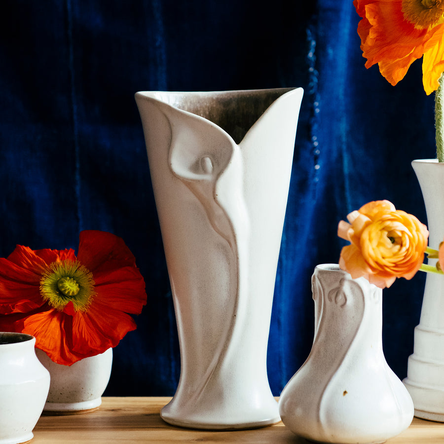 The ceramic Calla Lily vase features the matte white Birch glaze with natural speckles of iron dotting the surface of the glaze.