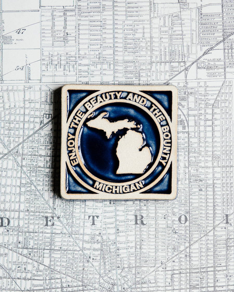The midnight/scrape version of the Michigan tile is glazed in the deep glossy blue color of Midnight. Before firing, the tile has been scraped, leaving the raised design without color.