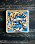 The Ford Piquette Tile is a two-tone color scheme. The words and design are scraped which gives it a light cream color while the background is a dark matte blue.