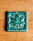 This Maple Leaf Tile features the matte blueish-green Pewabic Green glaze.