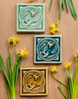 All three Daffodil color options are hung together with real daffodils surrounding them.