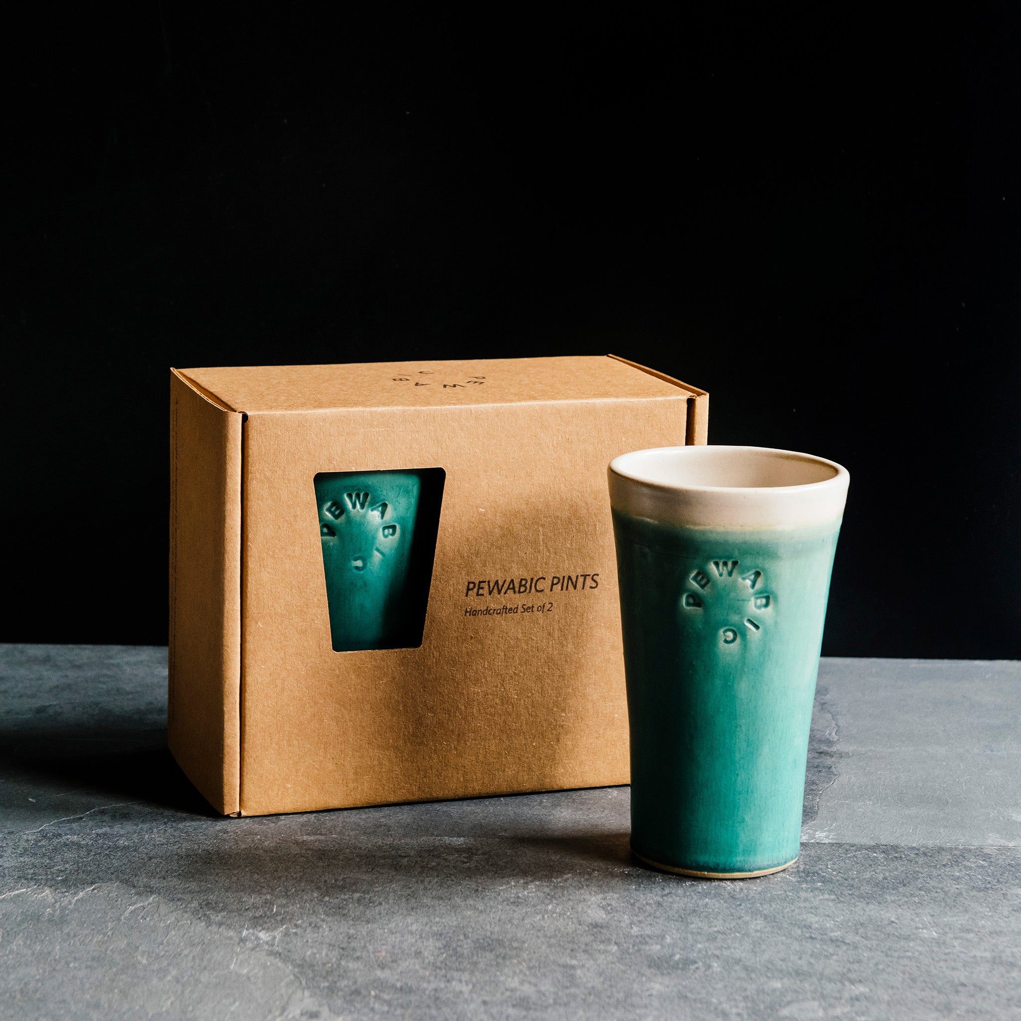 This pint set features the matte turquoise Pewabic Blue glaze with a white interior and lip.