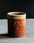 These Rocks cups feature the matte reddish-brown Cinnamon glaze. The inner lining and lip of the cup have a speckled gray.