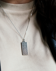 This antiqued sterling silver Guardian Building Pendant features a tile design found on the Guardian Building in downtown Detroit. The intricate geometric design sits on the completely silver colored rectangular pendant which hangs from a sterling silver chain.
