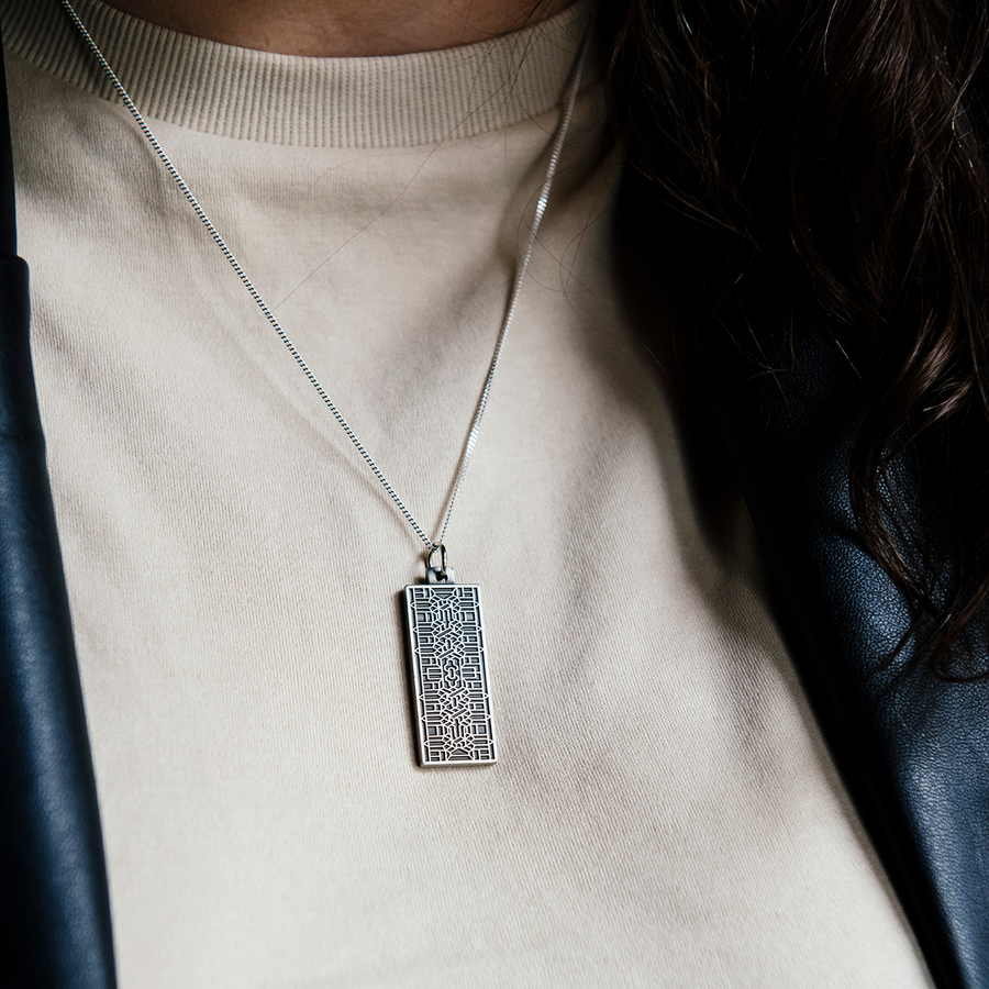 This antiqued sterling silver Guardian Building Pendant features a tile design found on the Guardian Building in downtown Detroit. The intricate geometric design sits on the completely silver colored rectangular pendant which hangs from a sterling silver chain.