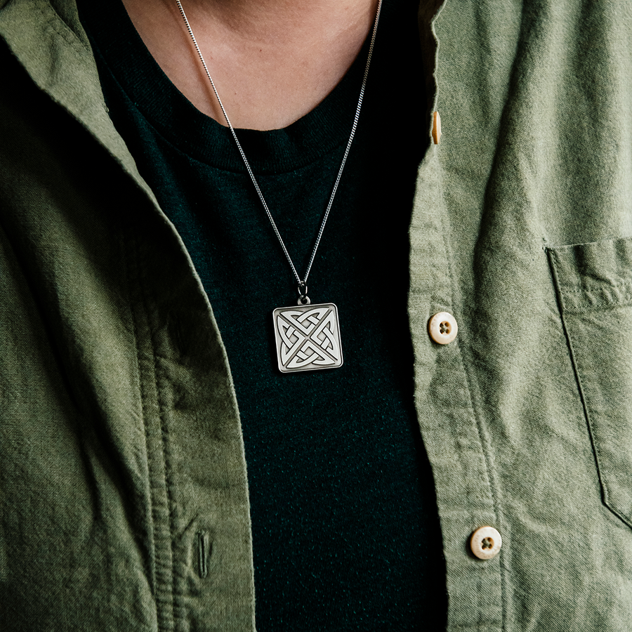 The silver-plated square Eternity Knot Pendant includes the design of two oval shapes intertwined to create the Celtic Eternity knot.