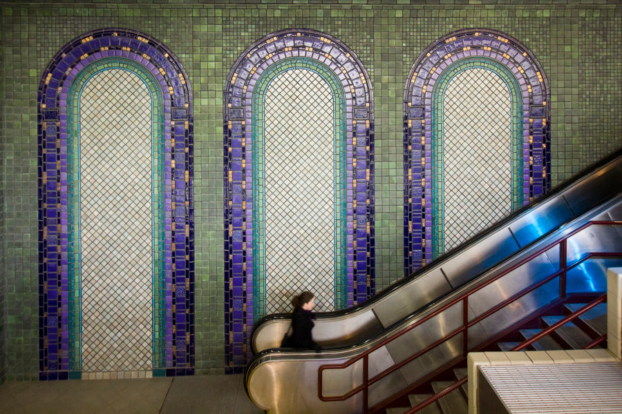 The tile mural at the People Mover in downtown Detroit features tall arches of tile in blues and greens. The sweeping mural is over 30 feet high and towers over the escalator leading up to the train.