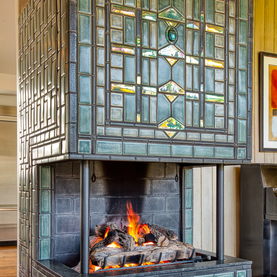 A detail shot of the fireplace from the front featuring our Matte Green Iridescent Scarab Paperweight design.
