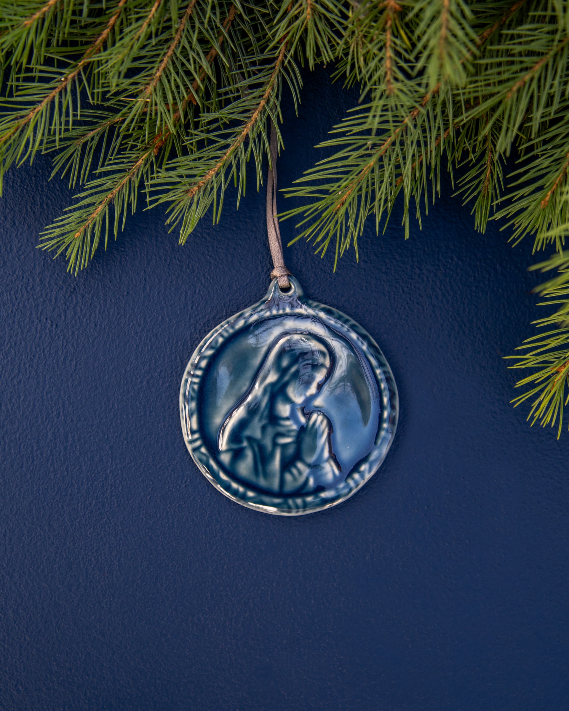 This ceramic Blessed Virgin Mary Ornament is glazed our rich, glossy, deep-blue Ocean glaze with a delicate ribbon string in shimmering taupe. 