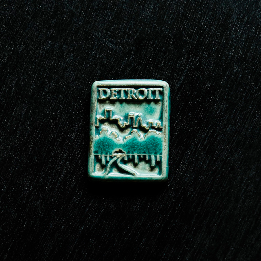 This magnet features the matte turquoise Pewabic Blue glaze.