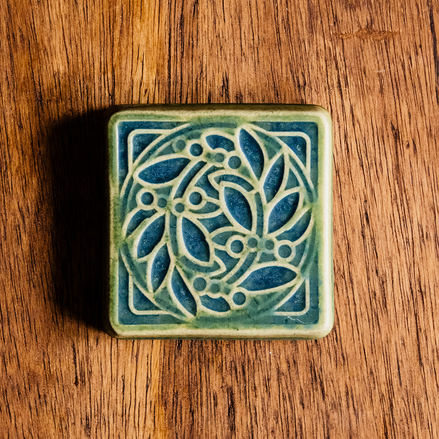 The raised portions of the tile are the matte bright light green Lime glaze while the background is the matte blue Lagoon glaze.