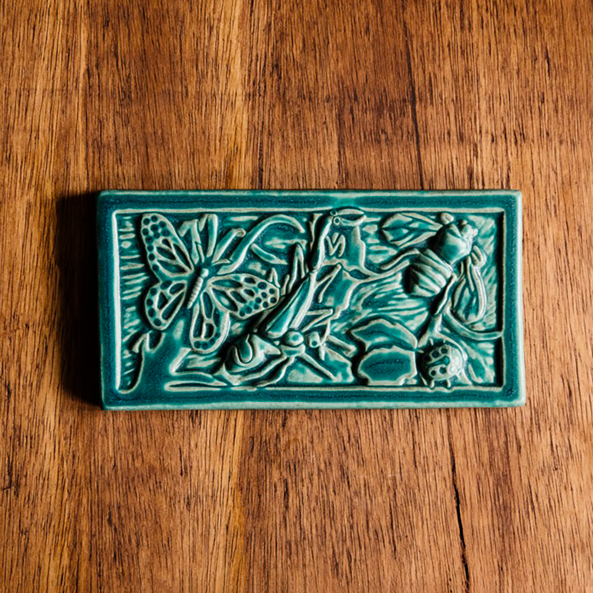 This tile is in the matte turquoise Pewabic Blue glaze.