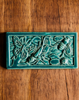 This tile is in the matte turquoise Pewabic Blue glaze.