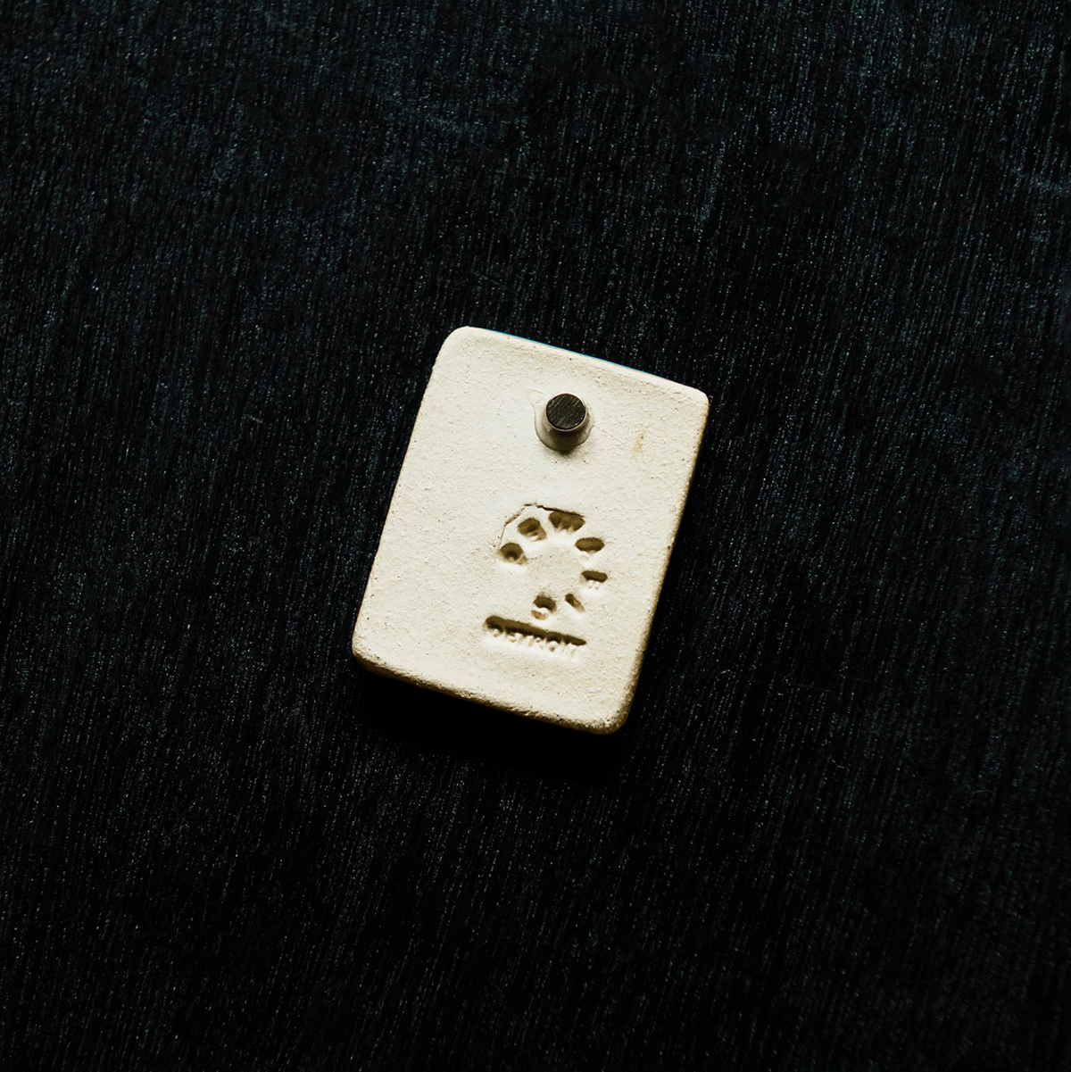 The back of the magnets feature a small but powerful round magnet attached to the tile with silicon glue. The Pewabic logo is stamped into the tile.