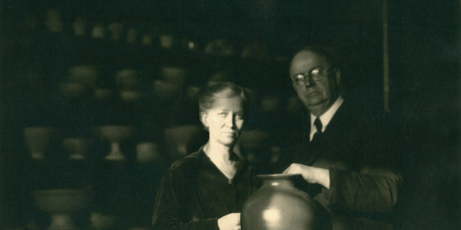 This historic image features Pewabic's co-founders Mary Chase Perry Stratton and Horace Caulkins posing with a large vase.