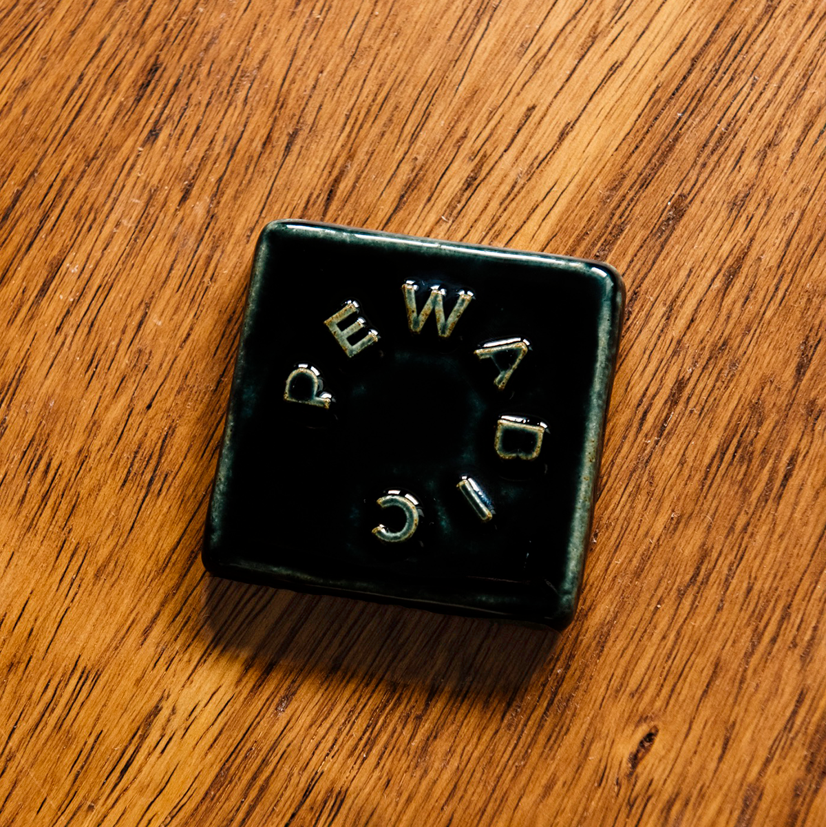 The tile features the glossy black Obsidian glaze.