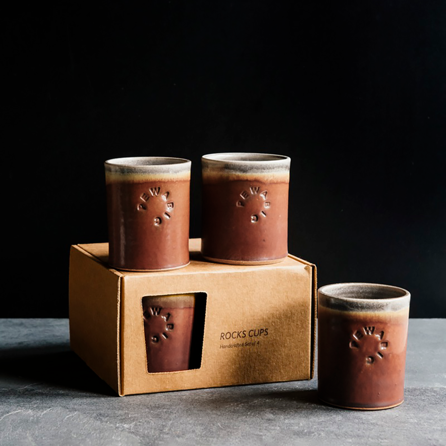 These Rocks Cups feature the matte brownish-red tones of the Cinnamon glaze. The inner lining and lip of the cup have a mottled gray color.