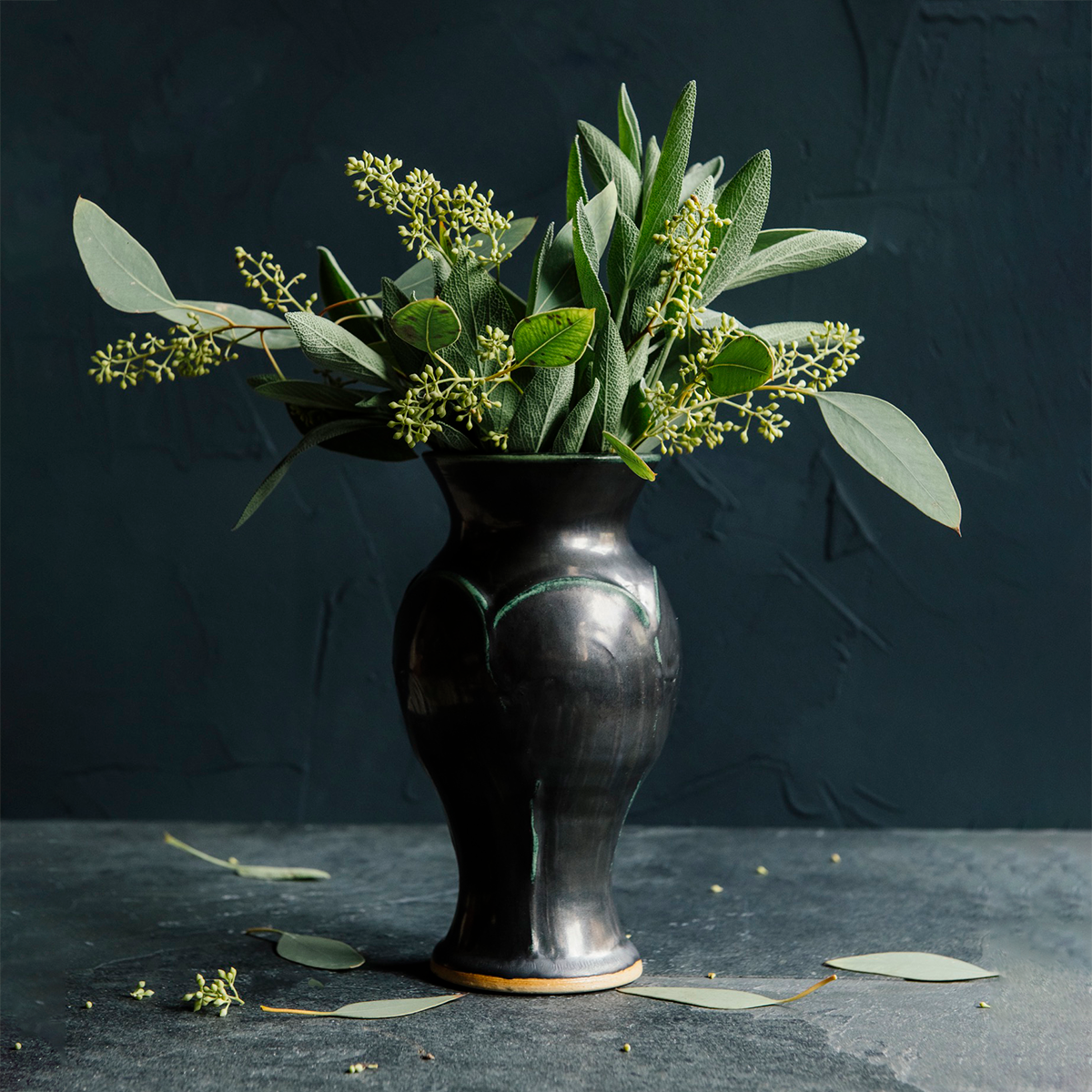 The Gun Metal glaze is a satin-finished steel black color. In areas where the glaze is thinner, like raised designs, it becomes a green color.