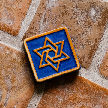 This square tile features a Star of David in its center with a simple line border around its edge.