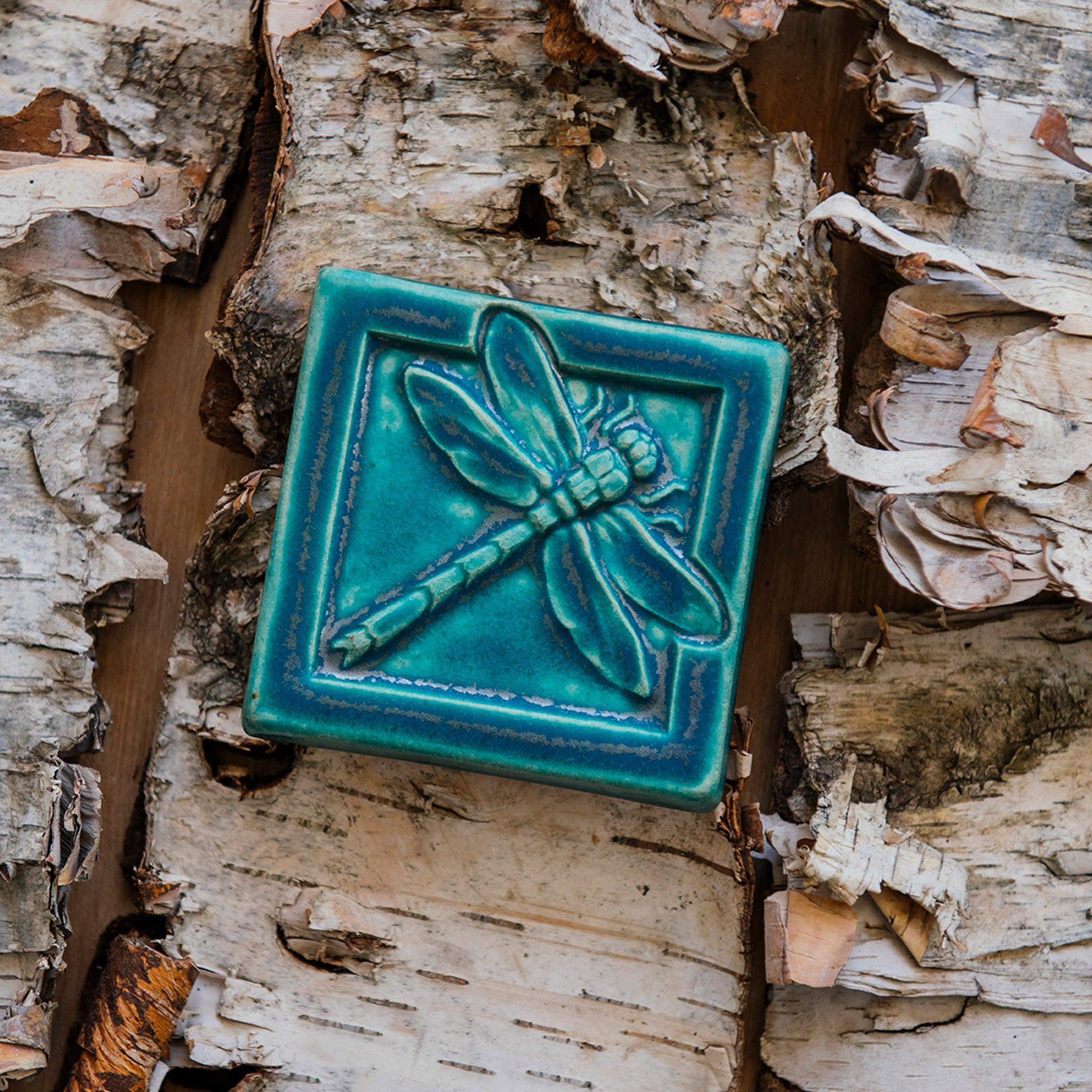 This Dragonfly Tile features the matte blueish-teal Pewabic Blue glaze.