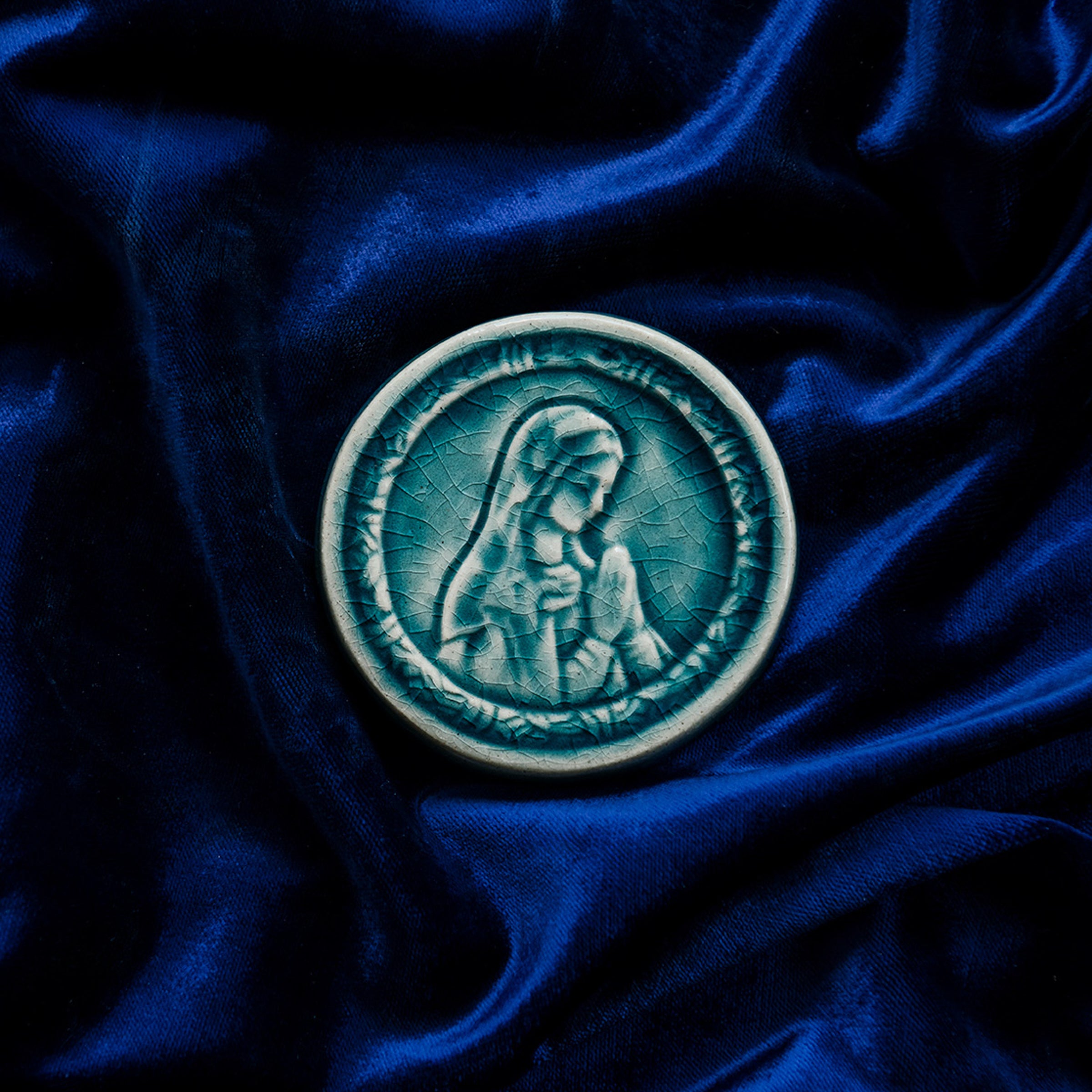This ceramic Blessed Virgin Mary Tile is glazed in a pale blue, glossy Glacier glaze. 