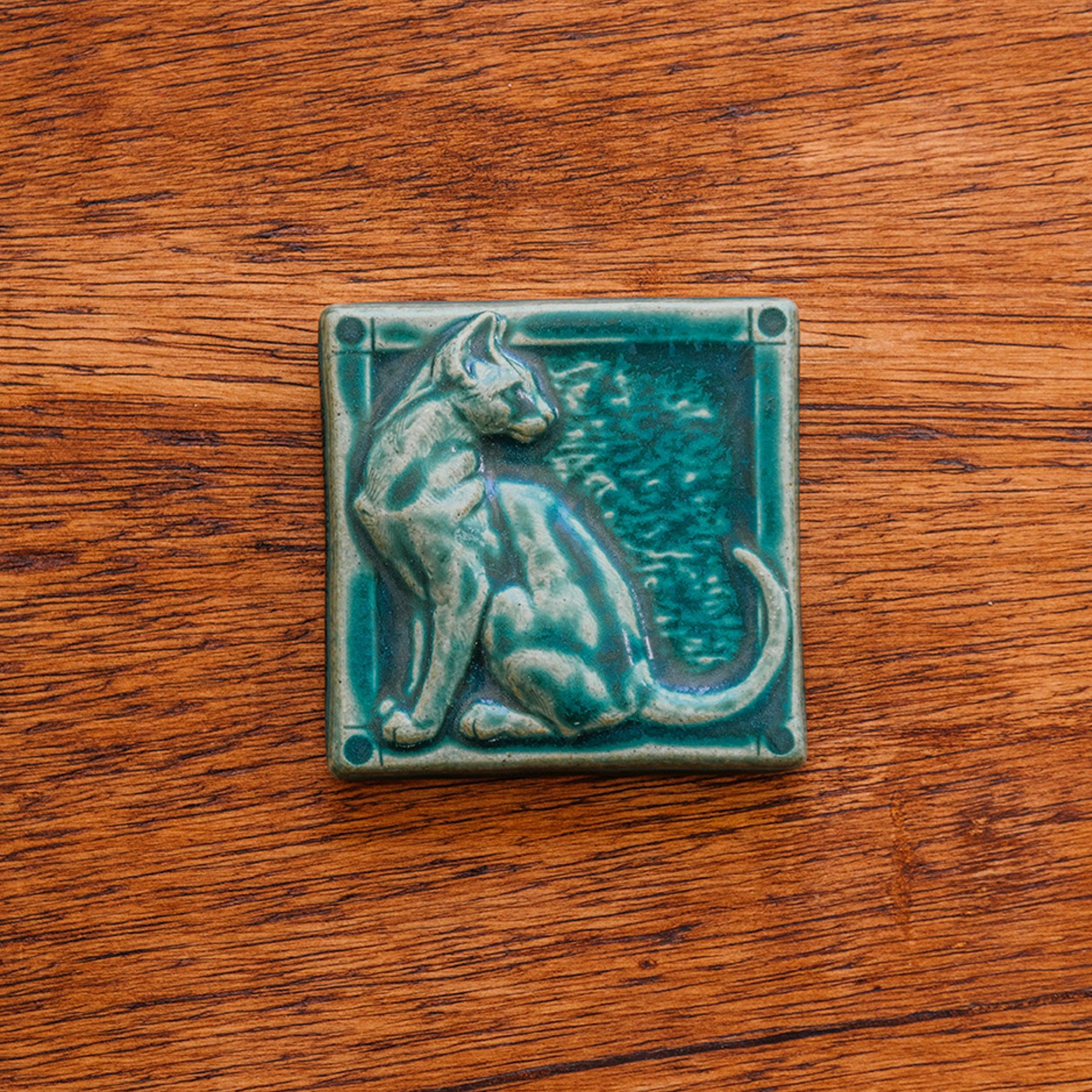 This cat tile is shown in a matte Pewabic green glaze.