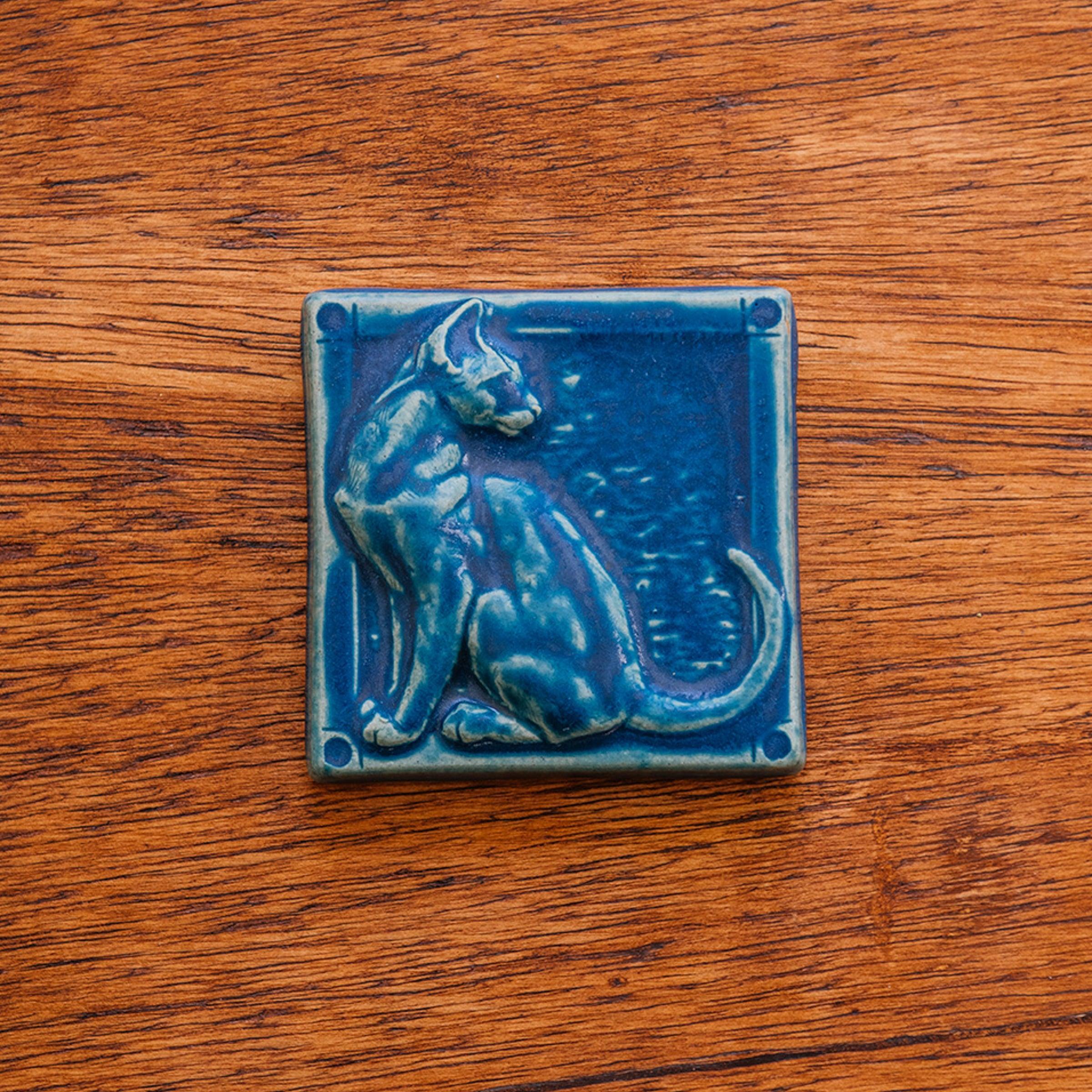 This cat tile is shown in a matte-blue Peacock glaze.