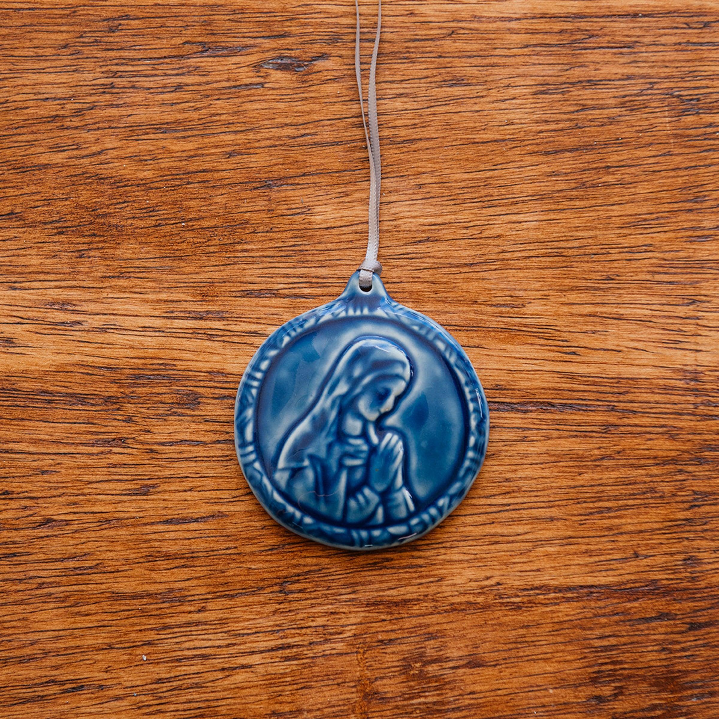 This ceramic Blessed Virgin Mary Ornament is glazed our rich, glossy, deep-blue Ocean glaze with a delicate ribbon string in shimmering taupe. 