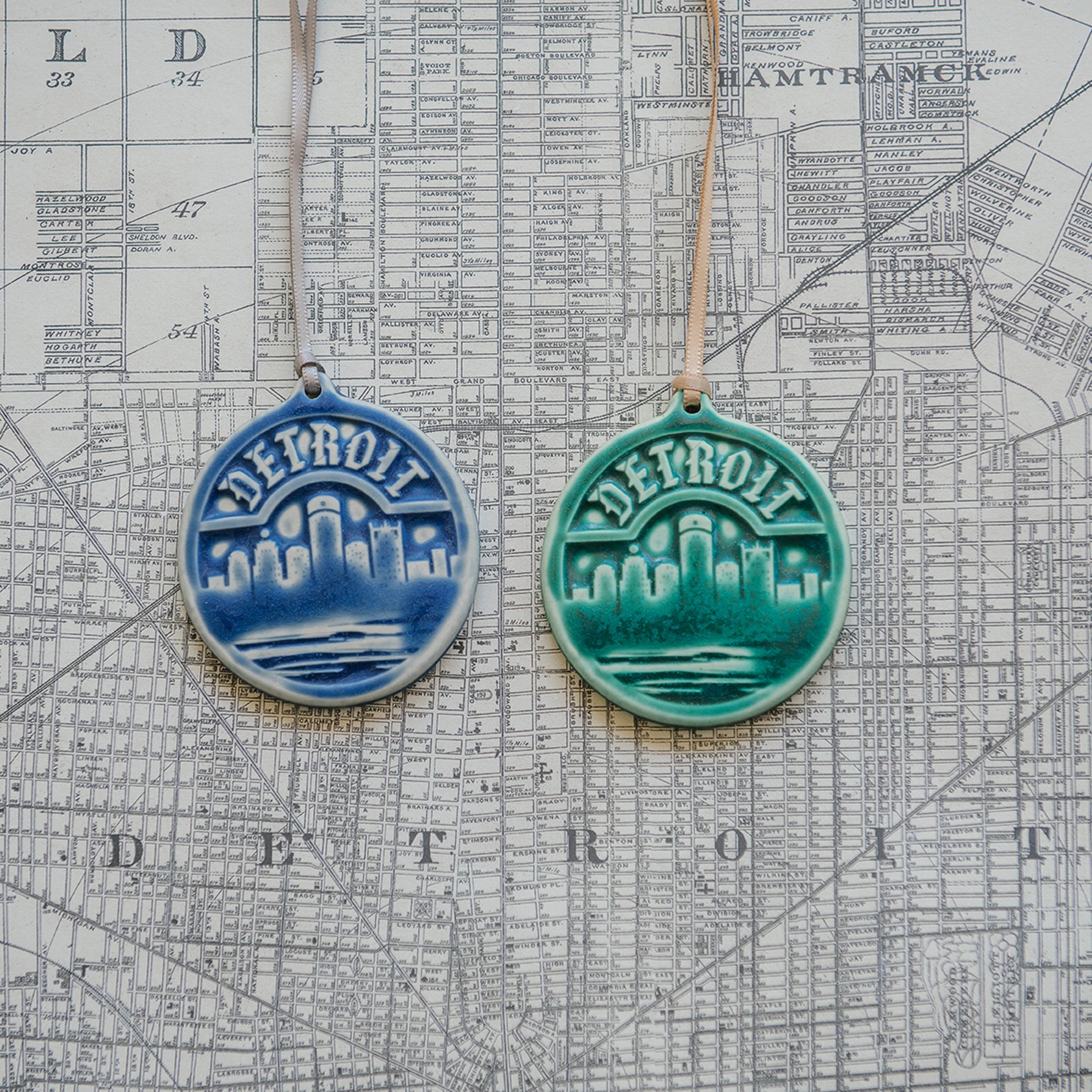 These Detroit Ornaments are featured in  the matte powder blue Steel and matte green Pewabic Green glazes. 