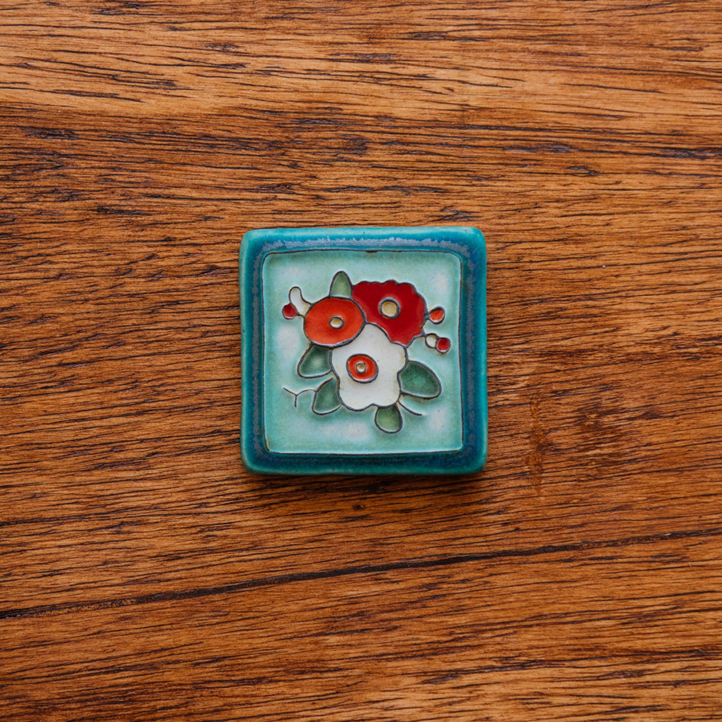 A Hand-Painted Three Flowers Tile in our "Poppy Palette."