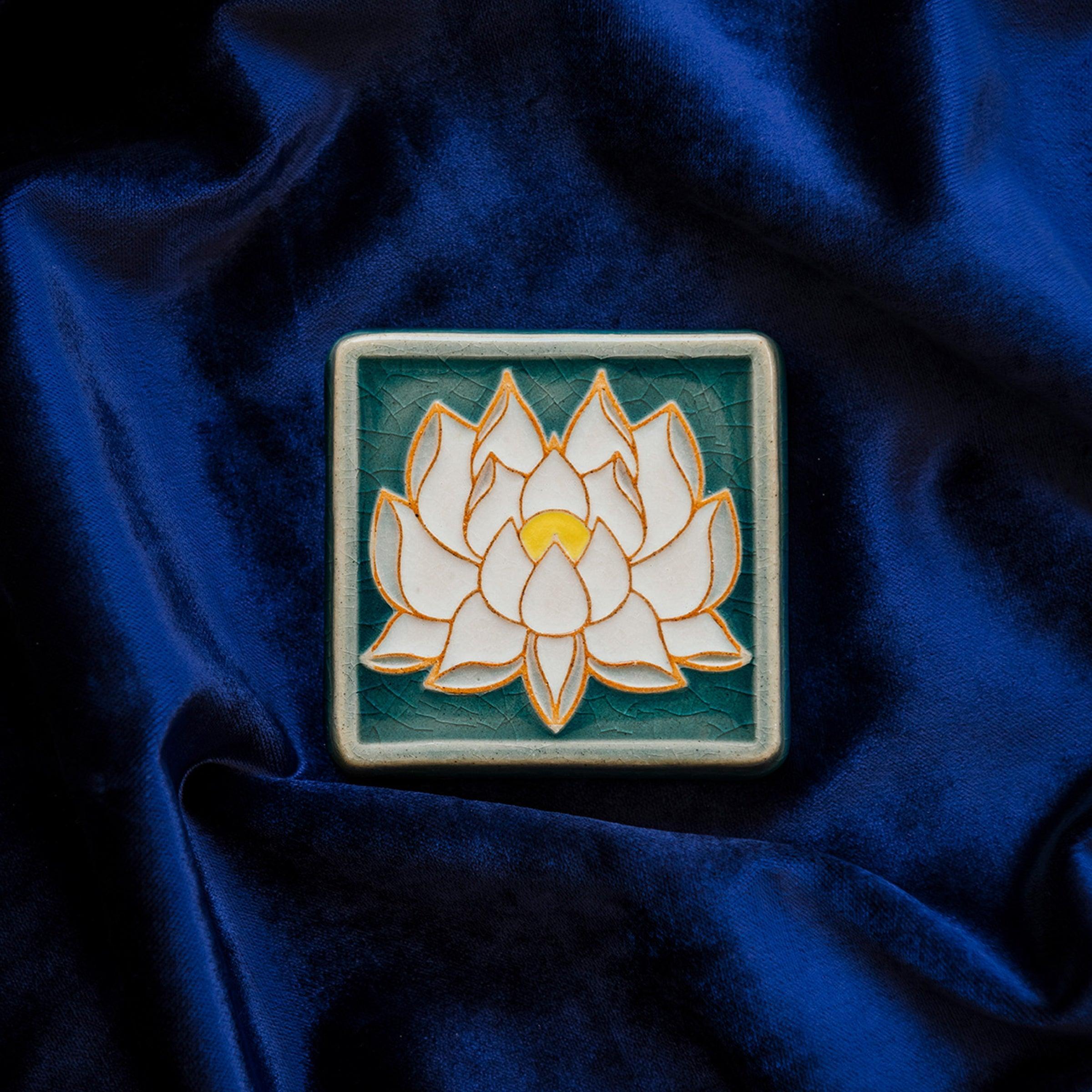 The Lotus tile features a line drawing of a blooming lotus flower, its pointed petals outstretching. It has a simple border around the design.
