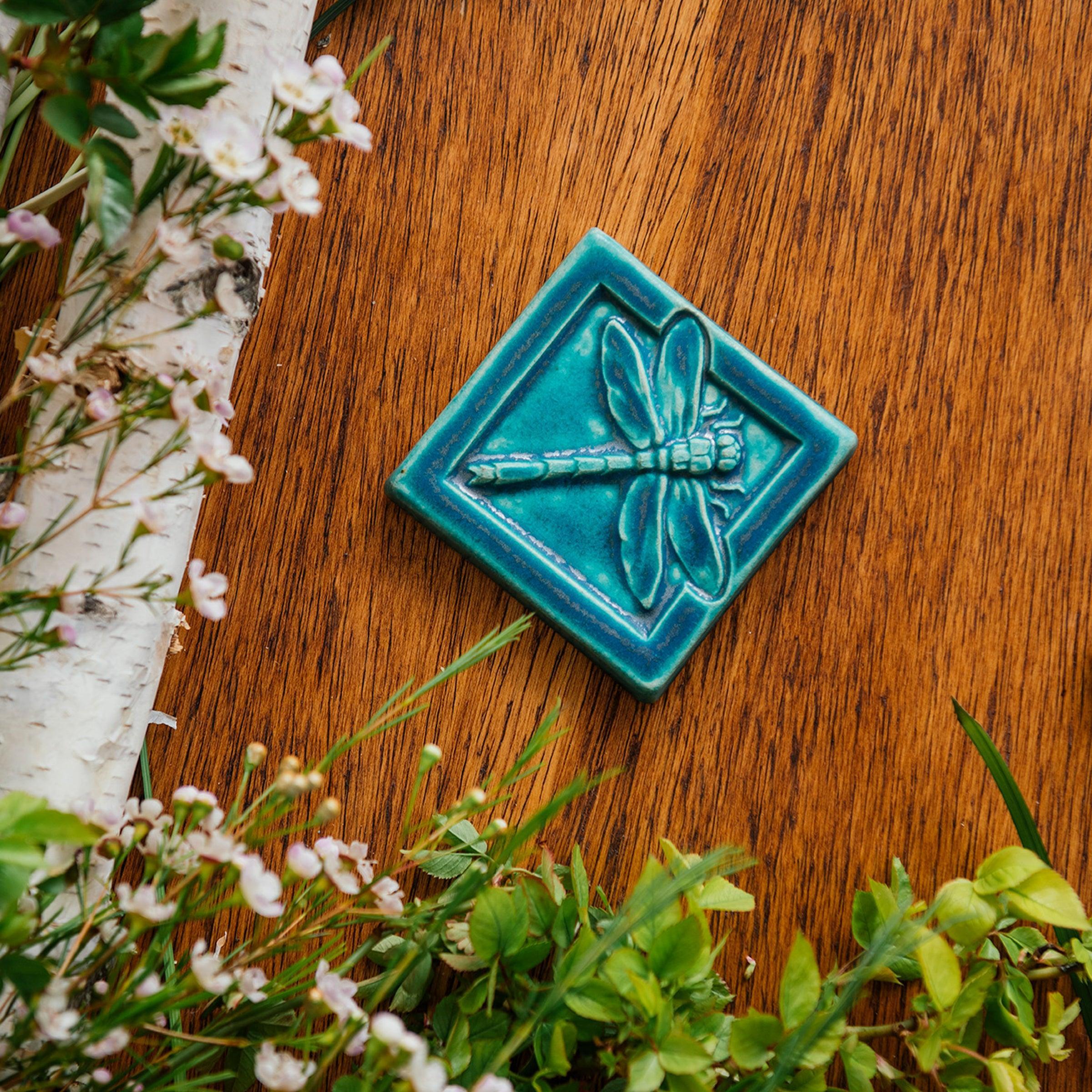 This Dragonfly Tile features the matte bluish-green Pewabic Blue glaze. 