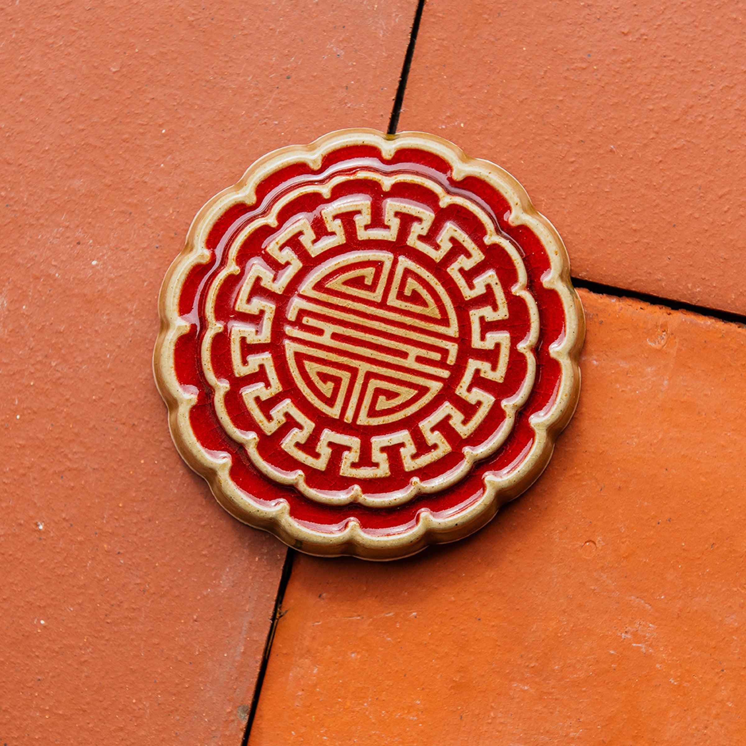 A Mooncake Paperweight in two-tone Scarlet/Honey.