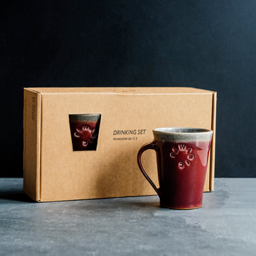 Cafe Mugs have a simple, modern design with smooth, straight sides that slant out. This makes the base slightly smaller than the cup's opening. The round Pewabic logo is stamped onto the side. This set of two mugs come in a specifically designed gift box.