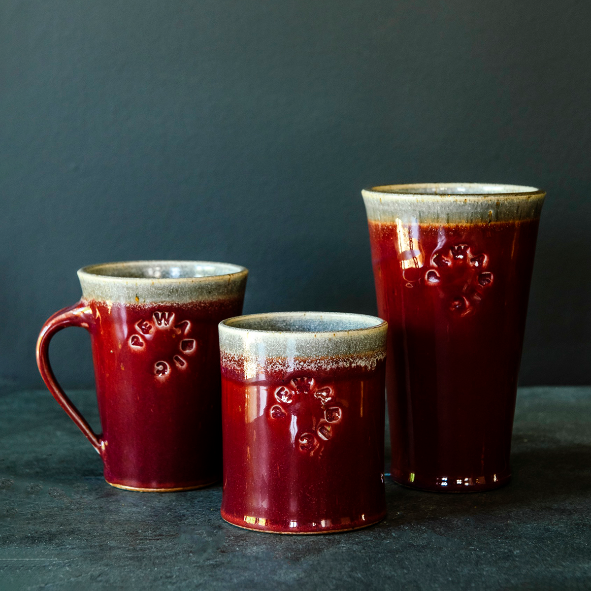 The Pewabic Pint sits amongst the other two drinking vessels that also feature the Pewabic logo and modern design: the Cafe Mug and the Rocks Cup. The Pint is the largest of the three designs.