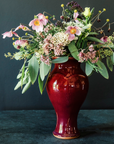 The Medium Classic Vase starts with a small diameter at its base that gradually gets larger until it contracts again near the top with a slightly wider lip. The sides of the vase have been swiped with slip, this gives the appearance of abstract petals overlapping on the widest part of the vase.