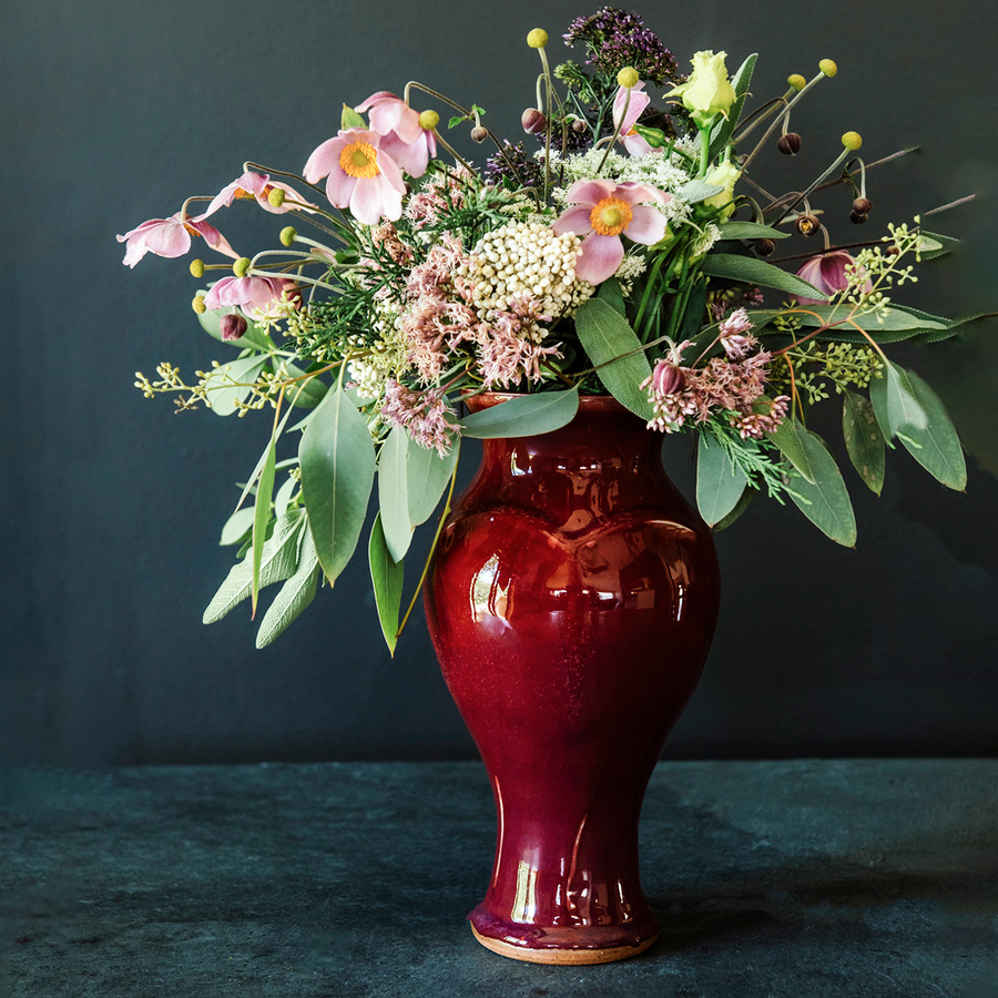 The Medium Classic Vase starts with a small diameter at its base that gradually gets larger until it contracts again near the top with a slightly wider lip. The sides of the vase have been swiped with slip, this gives the appearance of abstract petals overlapping on the widest part of the vase.