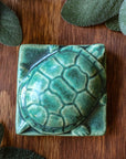 This paperweight features the matte blueish-green Pewabic Green glaze.