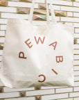 This tote has a sparkly copper colored logo.