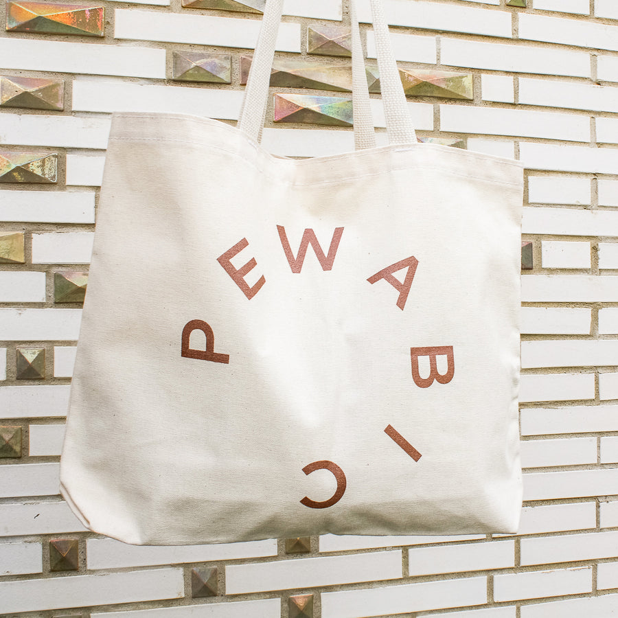 This tote has a sparkly copper colored logo.