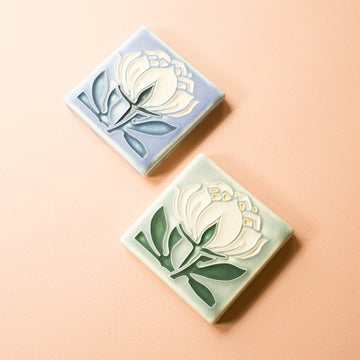 These brightly colored tiles each feature a line drawing of an art deco inspired peony.