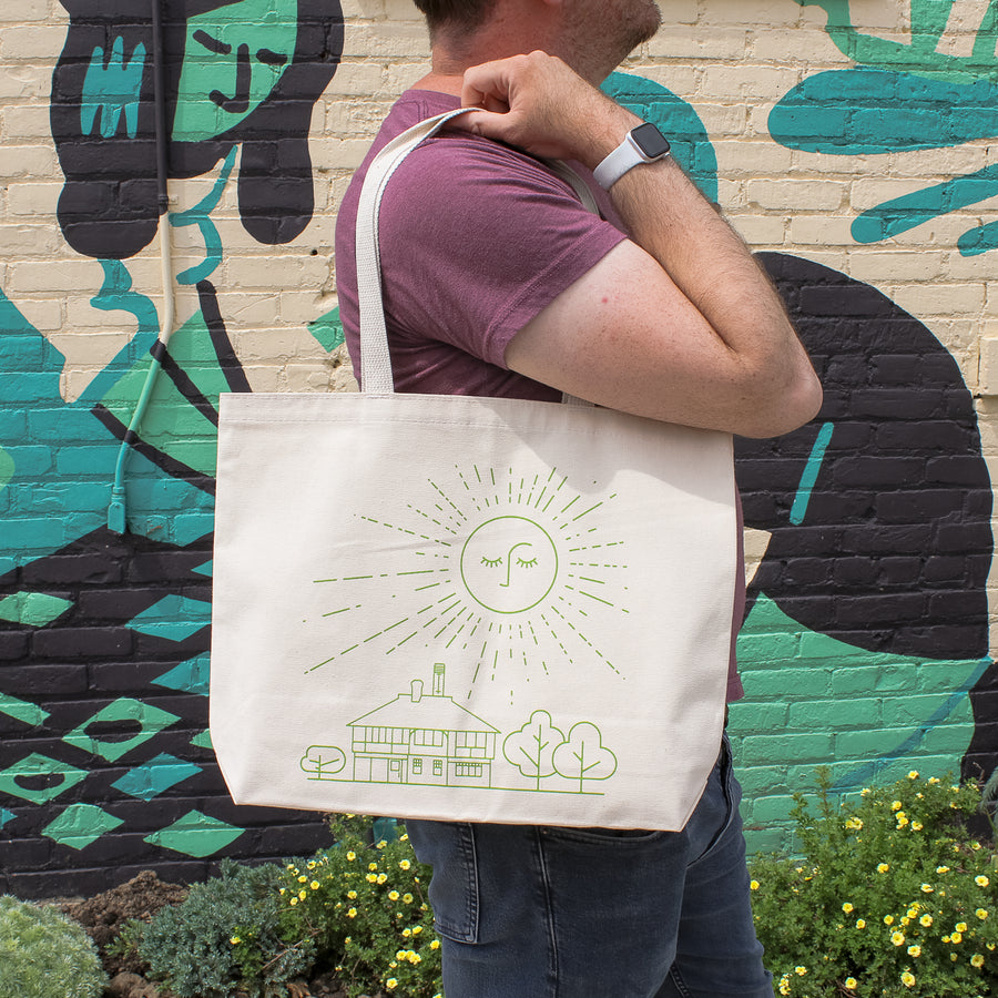 This cream tote bag's design is in a bright green color.